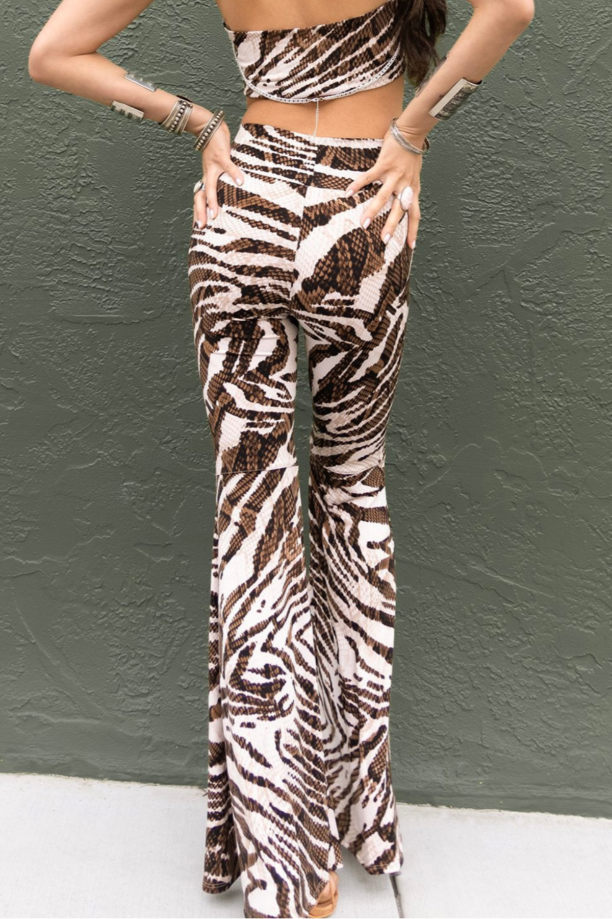 Person wearing a zebra print outfit against a gray wall.